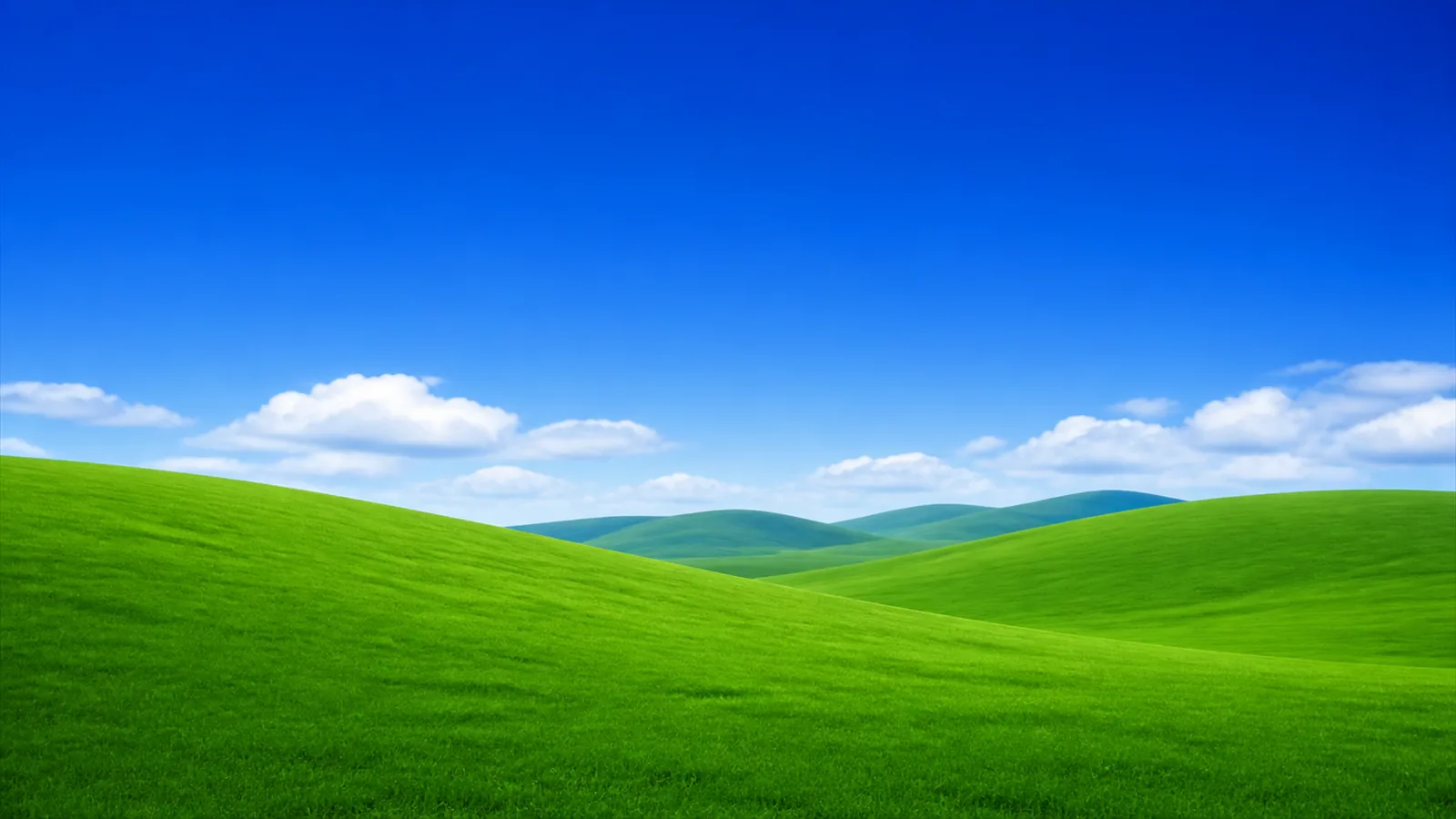 A green hill under a blue sky